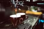 Photo of coffee machine pouring coffee into two cups at the same time by Chevanon